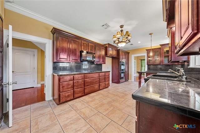 kitchen featuring black appliances, tasteful backsplash, hanging light fixtures, crown molding, and a notable chandelier