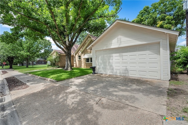 view of property exterior with a garage and a yard