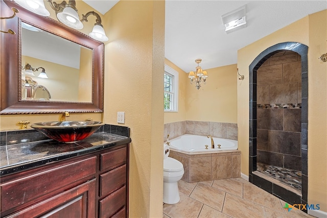 full bathroom with tile patterned flooring, shower with separate bathtub, vanity, and toilet