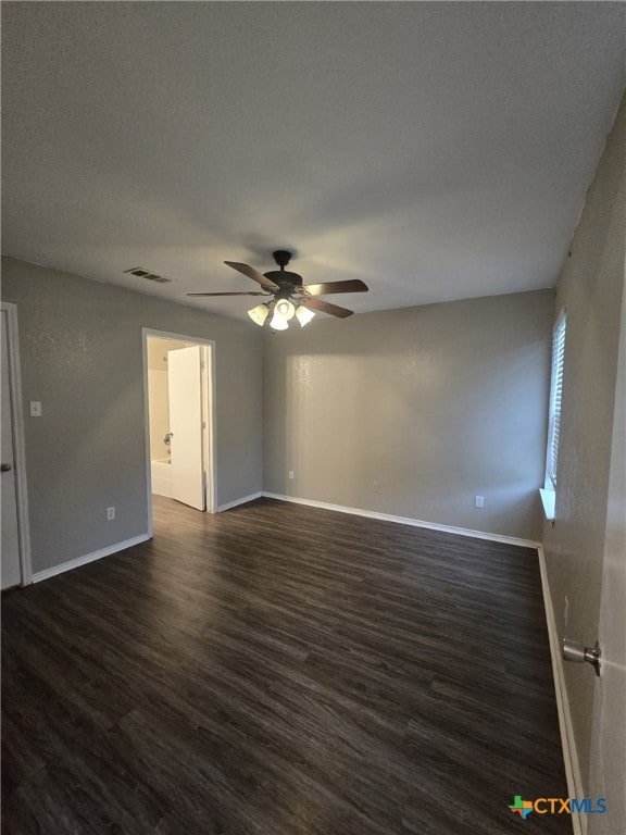 8630 Hogan Rd, Temple, TX 76502 - unfurnished room featuring ceiling fan, dark wood-style floors, and baseboards