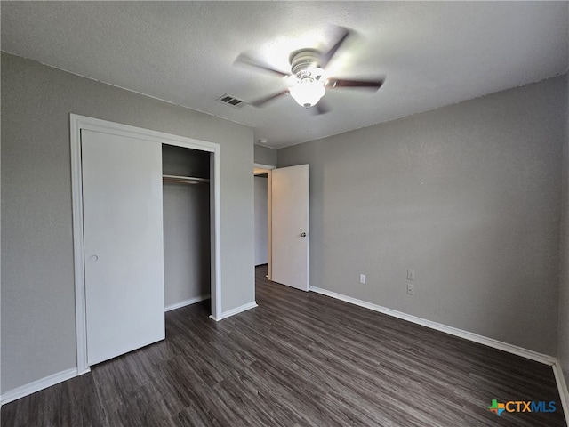 8630 Hogan Rd, Temple, TX 76502 - unfurnished bedroom featuring dark wood-style flooring, baseboards, a closet, and ceiling fan