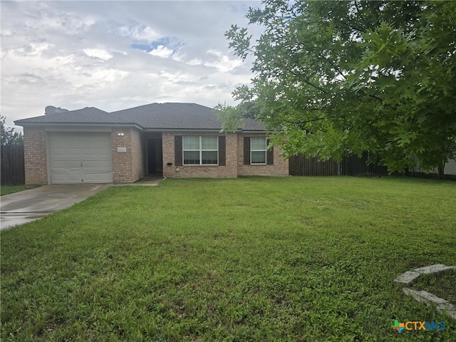 8630 Hogan Rd, Temple, TX 76502 - view of front of house featuring concrete driveway, brick siding, a front yard, and a garage