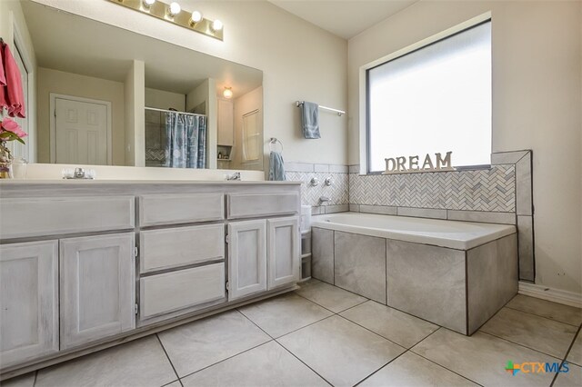 bathroom with independent shower and bath, vanity, and tile patterned floors