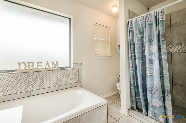 bathroom with tile patterned flooring, shower with separate bathtub, and toilet