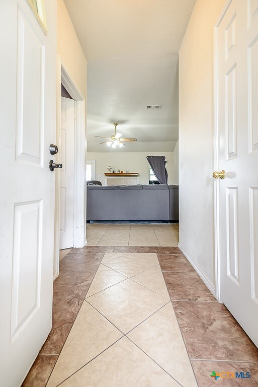 corridor with light tile patterned floors