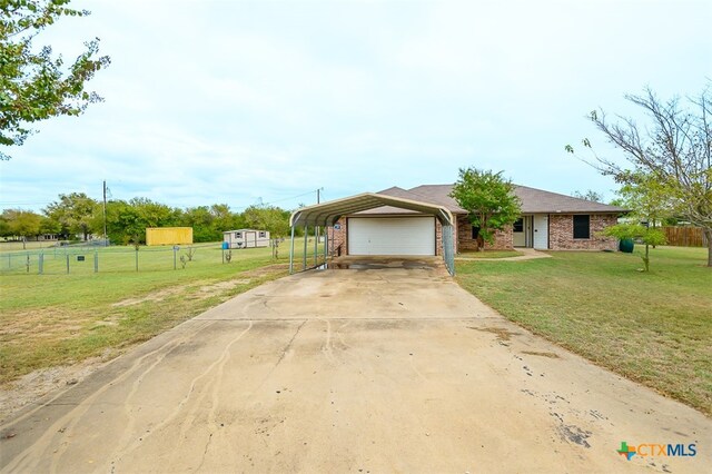 view of front facade featuring a front yard, a carport, and a garage