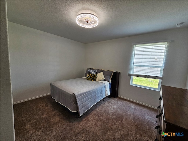 bedroom with dark colored carpet and multiple windows