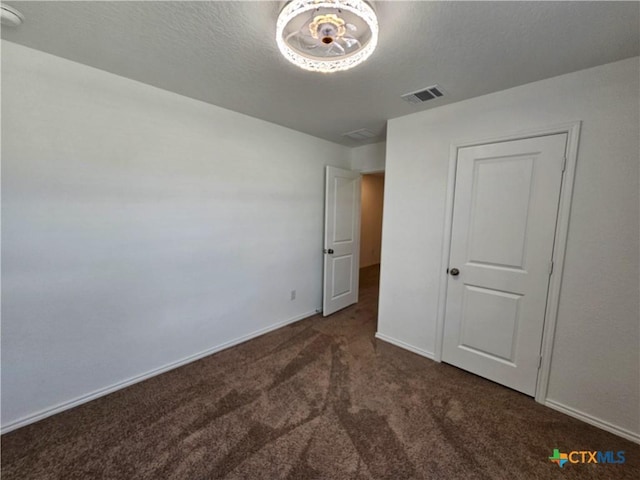 unfurnished bedroom featuring dark colored carpet