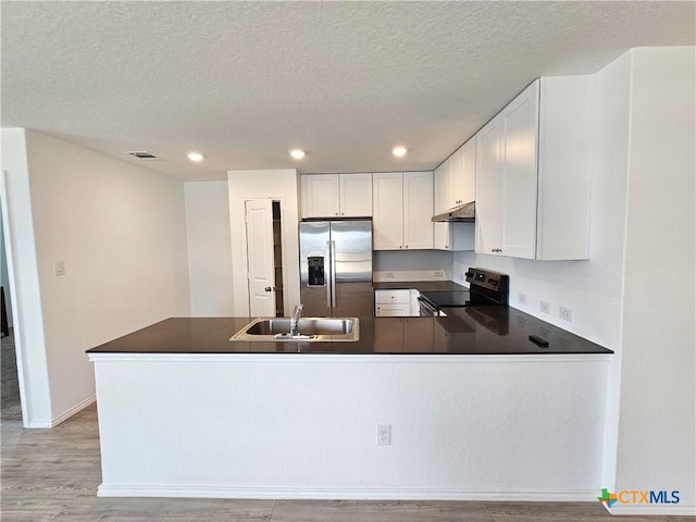 kitchen with sink, range with electric cooktop, stainless steel refrigerator with ice dispenser, a textured ceiling, and white cabinetry