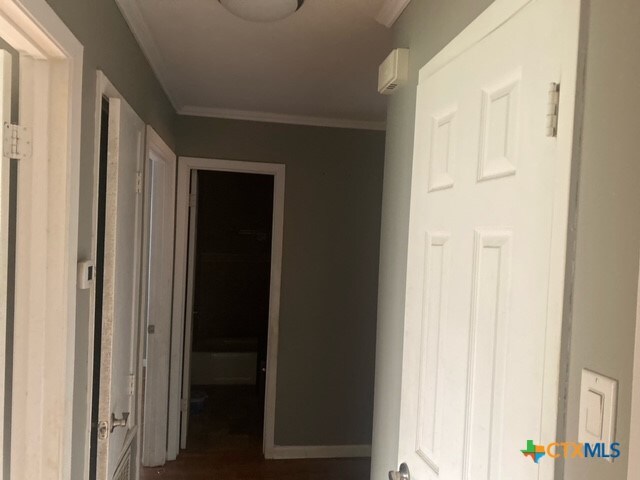 hallway featuring ornamental molding