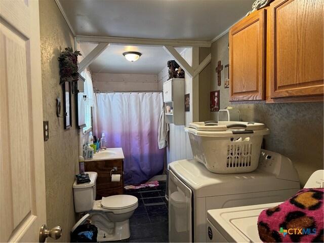 bathroom featuring toilet, tile patterned flooring, vanity, crown molding, and washing machine and dryer