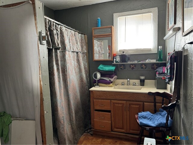 bathroom with vanity and parquet floors