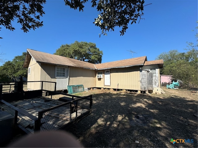 back of house with a wooden deck