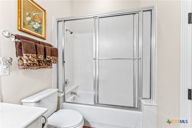 full bathroom with toilet, combined bath / shower with glass door, and vanity