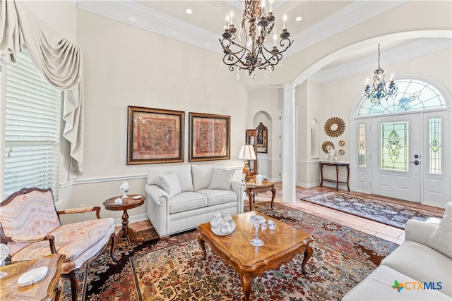 living room with tile patterned flooring, ornate columns, and ornamental molding