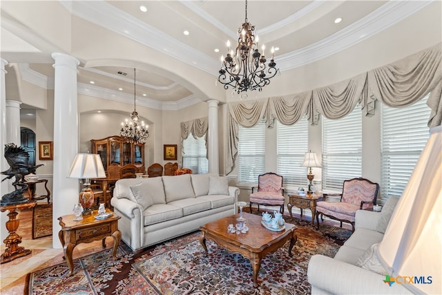 tiled living room with ornamental molding, a healthy amount of sunlight, and decorative columns