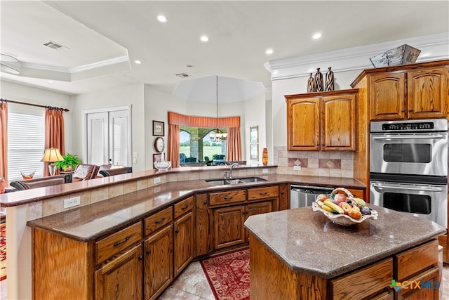 kitchen with appliances with stainless steel finishes, kitchen peninsula, tasteful backsplash, light tile patterned floors, and crown molding