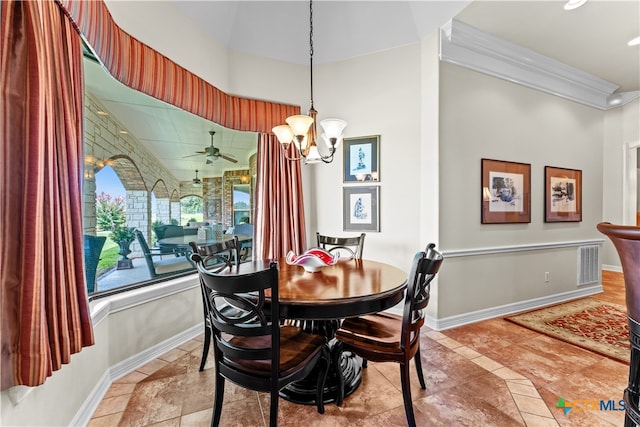 dining space featuring ceiling fan with notable chandelier and ornamental molding