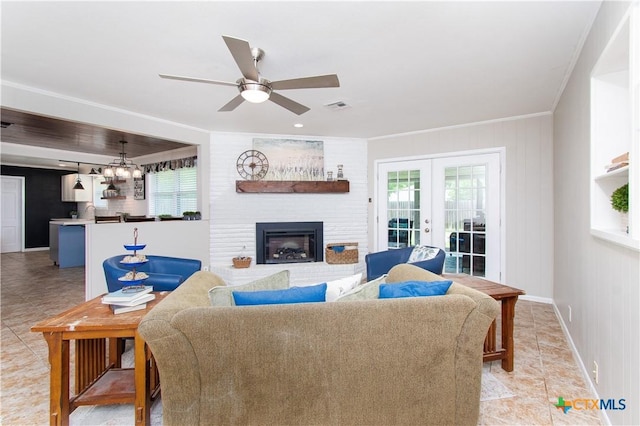 4512 Briar Cliff Rd, Temple, TX 76502 - living room with healthy amount of natural light, a ceiling fan, french doors, a brick fireplace, and ornamental molding