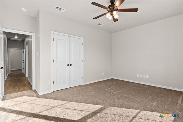 unfurnished bedroom with a closet, carpet flooring, and visible vents