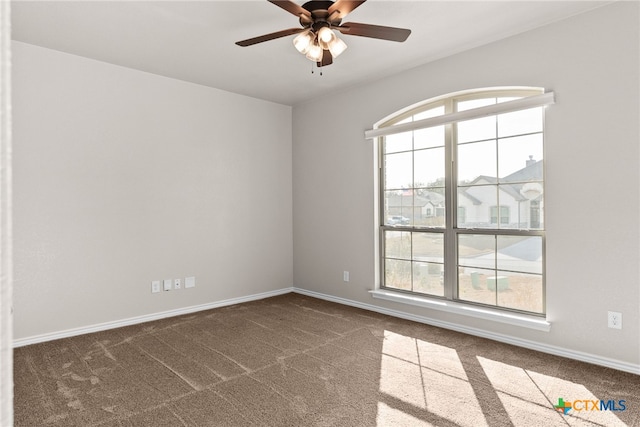 spare room featuring carpet flooring, plenty of natural light, and ceiling fan