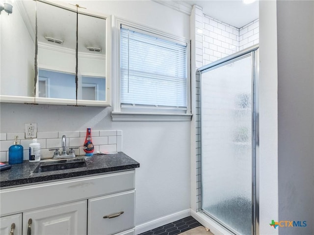 1000 Advance St, San Marcos, TX 78666 - bathroom featuring tasteful backsplash, vanity, baseboards, a shower stall, and visible vents
