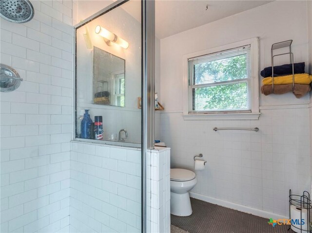 1000 Advance St, San Marcos, TX 78666 - full bathroom with toilet, a stall shower, tile patterned floors, and tile walls