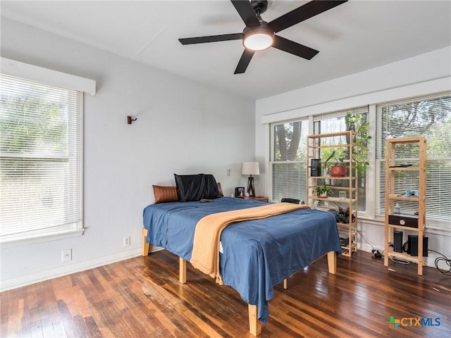 1000 Advance St, San Marcos, TX 78666 - bedroom with baseboards, hardwood / wood-style floors, and a ceiling fan