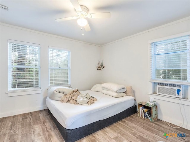 1000 Advance St, San Marcos, TX 78666 - bedroom with ceiling fan, cooling unit, crown molding, and wood finished floors