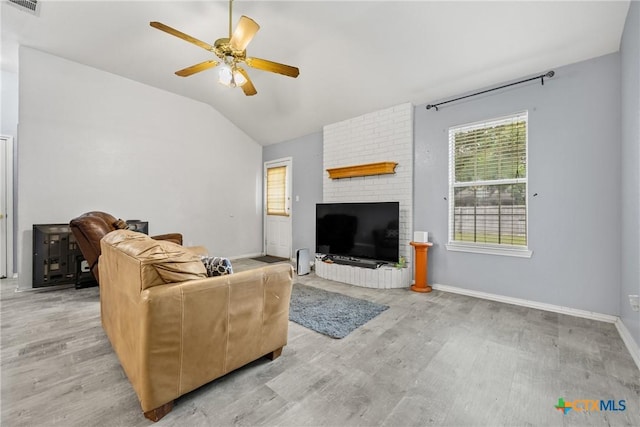 5404 Jim Ave, Killeen, TX 76549 - living room with lofted ceiling, light wood-style floors, a ceiling fan, a fireplace, and baseboards