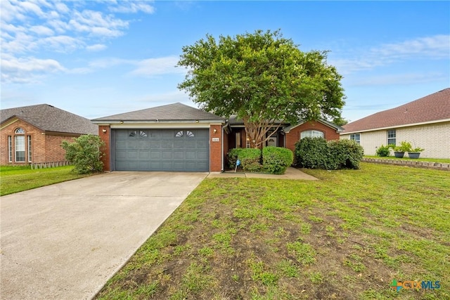 5404 Jim Ave, Killeen, TX 76549 - ranch-style home featuring brick siding, a garage, a front yard, and concrete driveway