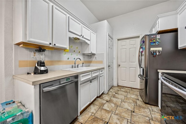 5404 Jim Ave, Killeen, TX 76549 - kitchen featuring appliances with stainless steel finishes, a sink, stone finish floors, white cabinets, and light countertops