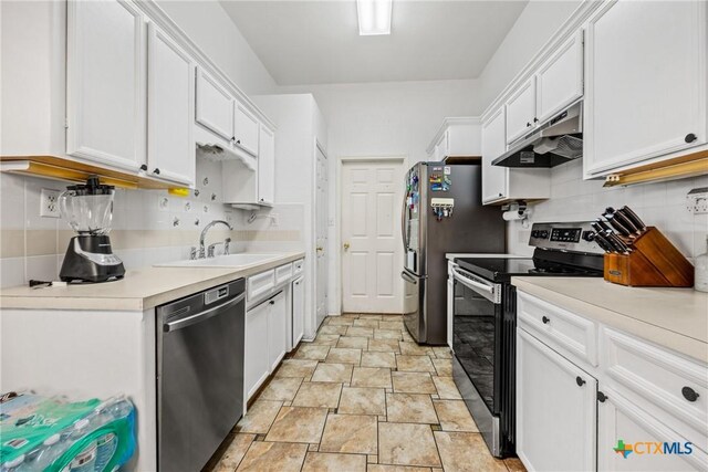 5404 Jim Ave, Killeen, TX 76549 - kitchen featuring stainless steel appliances, under cabinet range hood, white cabinetry, and tasteful backsplash