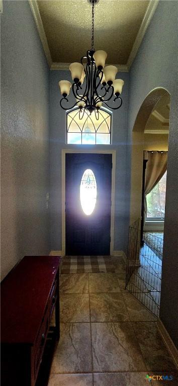 1122 Windy Hill Rd, Harker Heights, TX 76548 - foyer entrance with ornamental molding, a chandelier, and arched walkways