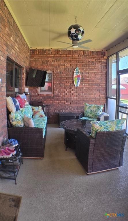 1122 Windy Hill Rd, Harker Heights, TX 76548 - living area with brick wall, ceiling fan, and carpet