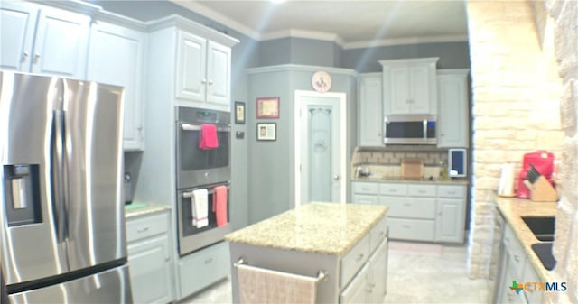 1122 Windy Hill Rd, Harker Heights, TX 76548 - kitchen with stainless steel appliances, ornamental molding, light stone counters, a kitchen island, and decorative backsplash