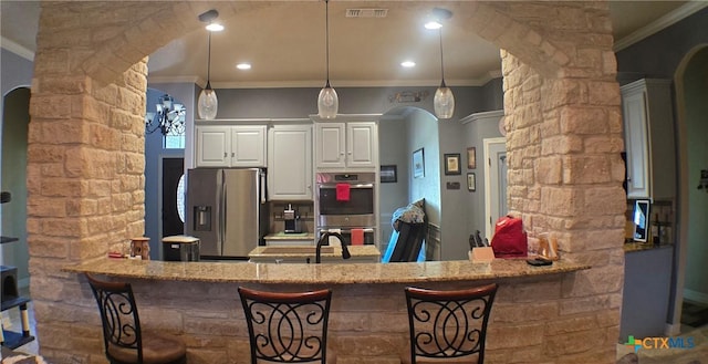 1122 Windy Hill Rd, Harker Heights, TX 76548 - kitchen featuring stainless steel appliances, ornamental molding, decorative columns, arched walkways, and recessed lighting