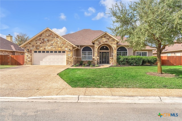 view of front of property with a garage and a front lawn