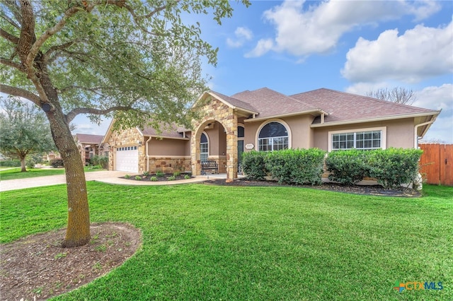 view of front of property with a garage and a front lawn