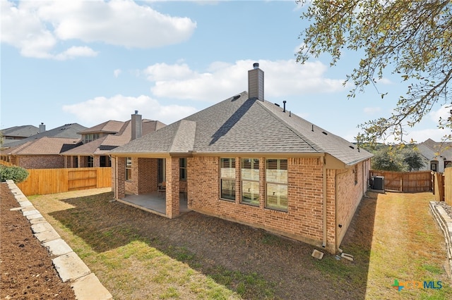 back of property with a patio, brick siding, and a fenced backyard