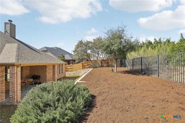 view of yard with a patio and a fenced backyard