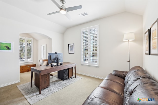 office space with visible vents, plenty of natural light, light colored carpet, and vaulted ceiling