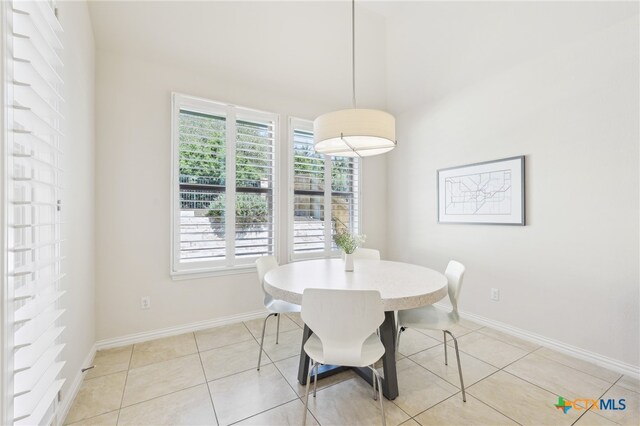 dining area with light tile patterned floors and baseboards