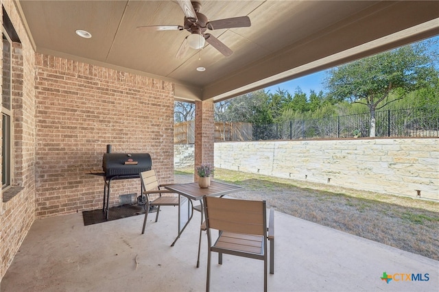 view of patio / terrace featuring area for grilling, a fenced backyard, and ceiling fan