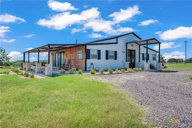 exterior space featuring a patio area and a front lawn