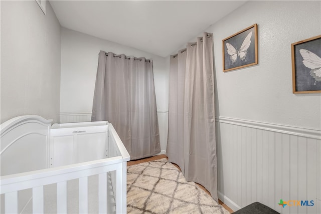 bedroom with a crib and lofted ceiling