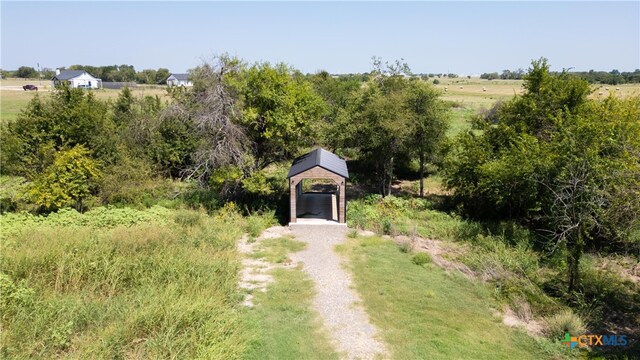 view of yard with a rural view