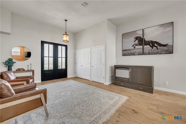 foyer entrance featuring wood-type flooring and french doors