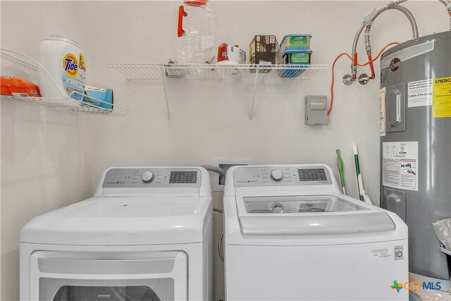 washroom with electric water heater and separate washer and dryer