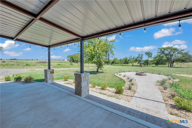 view of patio / terrace featuring a rural view and a fire pit